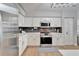 Updated kitchen with white cabinets, gray backsplash and stainless steel appliances at 11225 Scotchwood Dr, Riverview, FL 33579
