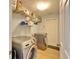 Laundry room with washer, dryer, and shelving for storage at 11225 Scotchwood Dr, Riverview, FL 33579