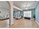 Open concept living room with hardwood floors, light walls, and a large window at 11225 Scotchwood Dr, Riverview, FL 33579