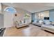 Open living area featuring hardwood floors, large windows, and ample natural light at 11225 Scotchwood Dr, Riverview, FL 33579
