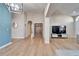 Bright and airy entryway to living room with hardwood floors and built-in storage at 11225 Scotchwood Dr, Riverview, FL 33579