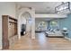 Spacious living area with hardwood floors, an L-shaped sofa, and a coat rack at 11225 Scotchwood Dr, Riverview, FL 33579