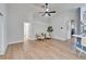 Light and airy living room with hardwood floors and access to other rooms at 11225 Scotchwood Dr, Riverview, FL 33579