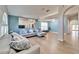 Light and airy living room with vaulted ceilings, L-shaped sofa, and hardwood floors at 11225 Scotchwood Dr, Riverview, FL 33579