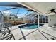 Screened-in pool area with lounge chairs and a waterfall feature at 11225 Scotchwood Dr, Riverview, FL 33579
