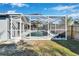 Inviting screened-in pool and patio with a wooden fence at 11225 Scotchwood Dr, Riverview, FL 33579