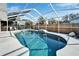 Refreshing screened-in pool with a waterfall and plenty of space for relaxation at 11225 Scotchwood Dr, Riverview, FL 33579