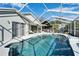 Inviting screened-in pool with patio furniture and lush greenery at 11225 Scotchwood Dr, Riverview, FL 33579