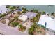 Aerial view of a home on a canal with a neighboring property undergoing demolition at 11325 6Th E St, Treasure Island, FL 33706