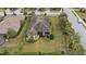 Home's backyard with a covered patio and lush landscaping at 11465 Bitola Dr, Odessa, FL 33556