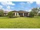 Spacious backyard with a screened-in patio and manicured lawn at 11465 Bitola Dr, Odessa, FL 33556