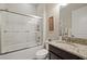 Clean bathroom with granite vanity and a tub shower combo at 11465 Bitola Dr, Odessa, FL 33556