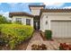 House exterior featuring a covered entryway and lush landscaping at 11465 Bitola Dr, Odessa, FL 33556