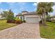 Single-story home with a two-car garage and well-maintained landscaping at 11465 Bitola Dr, Odessa, FL 33556