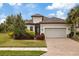 Single-story home with a two-car garage and attractive landscaping at 11465 Bitola Dr, Odessa, FL 33556