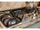Stainless steel gas cooktop with lit burner, showcasing its functionality at 11465 Bitola Dr, Odessa, FL 33556