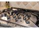 Close-up view of a modern gas cooktop with multiple burners at 11465 Bitola Dr, Odessa, FL 33556