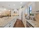 Open kitchen with island, stainless steel appliances, and hardwood floors at 11465 Bitola Dr, Odessa, FL 33556