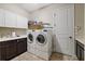Laundry room with washer, dryer, and cabinets at 11465 Bitola Dr, Odessa, FL 33556