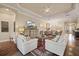 Spacious living room features hardwood floors, comfortable seating, and a large TV at 11465 Bitola Dr, Odessa, FL 33556