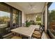 Relaxing screened patio with outdoor dining set and built-in grill at 11465 Bitola Dr, Odessa, FL 33556