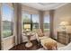 Bedroom sitting area with comfortable chair and ottoman, offering relaxing space at 11465 Bitola Dr, Odessa, FL 33556