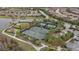 Two tennis courts with surrounding landscaping and parking at 11465 Bitola Dr, Odessa, FL 33556