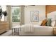 Bedroom with a neutral color scheme and striped bedding at 12422 Sweet Angel Aura Way, Parrish, FL 34219