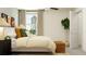Bright bedroom with a queen bed, neutral decor, and natural light at 12422 Sweet Angel Aura Way, Parrish, FL 34219