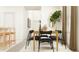 Modern dining room featuring a wood table and six black chairs at 12422 Sweet Angel Aura Way, Parrish, FL 34219