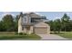 Two-story house with gray and beige siding, two-car garage, and landscaping at 12422 Sweet Angel Aura Way, Parrish, FL 34219