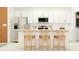 Modern kitchen boasts white cabinets and an island with seating at 12422 Sweet Angel Aura Way, Parrish, FL 34219