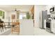 Open kitchen with white cabinets, stainless steel appliances, and an island at 12422 Sweet Angel Aura Way, Parrish, FL 34219