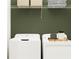 Convenient laundry room with washer, dryer, and shelving at 12422 Sweet Angel Aura Way, Parrish, FL 34219
