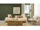 Bright living room features a comfy sofa, coffee table, and accent chair at 12422 Sweet Angel Aura Way, Parrish, FL 34219