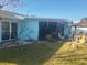 Backyard view showing a screened lanai and patio at 1279 Dinnerbell E Ln, Dunedin, FL 34698