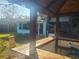 Outdoor bar area with tiki hut and string lights at 1279 Dinnerbell E Ln, Dunedin, FL 34698
