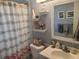 Bathroom with flamingo decor, updated vanity, and shower at 1279 Dinnerbell E Ln, Dunedin, FL 34698