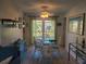 Bright dining room with glass table and four chairs at 1279 Dinnerbell E Ln, Dunedin, FL 34698