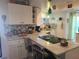 Updated kitchen featuring white cabinets, marble countertops, and breakfast bar at 1279 Dinnerbell E Ln, Dunedin, FL 34698