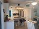 Modern kitchen with white cabinets, marble countertops, and stainless steel appliances at 1279 Dinnerbell E Ln, Dunedin, FL 34698