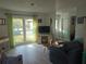 Spacious living room featuring light wood floors and plenty of natural light at 1279 Dinnerbell E Ln, Dunedin, FL 34698