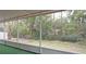 Screened porch overlooking a tranquil wooded area with a creek at 13225 Royal George Ave, Odessa, FL 33556