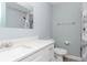 Updated bathroom with white vanity, white subway tile shower, and grey walls at 1341 Springdale St, Clearwater, FL 33755
