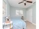 Bedroom with light blue bedding, ceiling fan and window at 1341 Springdale St, Clearwater, FL 33755