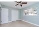 Bedroom with grey walls, wood-look flooring, and double door closet at 1341 Springdale St, Clearwater, FL 33755