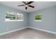 Bedroom with grey walls, wood-look flooring, and two windows at 1341 Springdale St, Clearwater, FL 33755