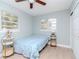 Bedroom with light blue bedding, ceiling fan and window at 1341 Springdale St, Clearwater, FL 33755
