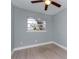 Spacious bedroom with a window, ceiling fan, and light gray walls at 1341 Springdale St, Clearwater, FL 33755