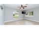 Bedroom with grey walls, wood-look flooring, and two large windows at 1341 Springdale St, Clearwater, FL 33755